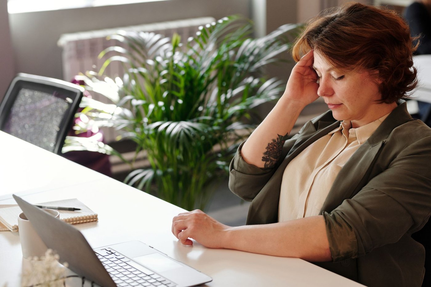 A tired woman at her desk
